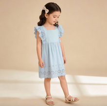 Load image into Gallery viewer, Young girl wearing a light blue dress with lace details on a beige background
