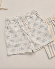 Load image into Gallery viewer, Pair of shorts with palm tree pattern on a light background
