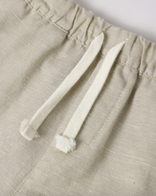 Load image into Gallery viewer, Close-up of beige pants with white drawstrings on a light background
