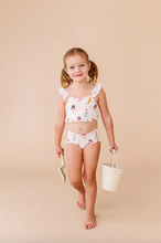 Load image into Gallery viewer, Young girl in a mermaid swimsuit holding a bucket against a beige background
