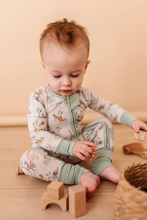 Load image into Gallery viewer, Baby playing with wooden toys on a wooden floor against a beige wall
