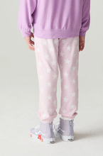 Load image into Gallery viewer, A child shown from the back wearing light pink jogger pants with a white star pattern, a lavender sweatshirt, and white high-top sneakers on a light gray studio background.
