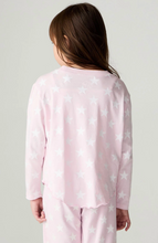 Load image into Gallery viewer, A child shown from the back wearing a light pink long-sleeve pajama top and matching pants, both printed with a white star pattern, against a plain light gray studio background.
