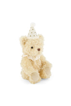 Load image into Gallery viewer, Angled front view of Party Arthur teddy bear, showing fluffy ivory fur, smooth paw pads, and a pom-pom party hat.
