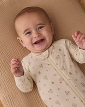 Load image into Gallery viewer, Close-up of a smiling baby wearing the cream Hanukkah footie, showing the neckline, zipper guard, and festive print.
