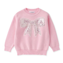 Load image into Gallery viewer, A pink crewneck sweater featuring a large, sparkling sequined bow design on the chest, displayed against a clean white background.
