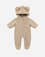 Load image into Gallery viewer, Latte tan fleece baby jumpsuit with a bear-ear hood, front zipper, long sleeves, and enclosed feet on a white background.
