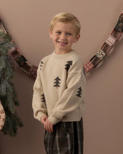 Load image into Gallery viewer, Aspen Sweater in Tree Jacquard, cream on a boy by a garland
