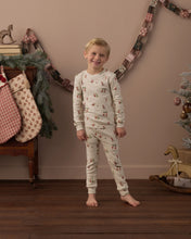 Load image into Gallery viewer, Organic Long Sleeve PJ Set in Gnome Village on a boy by holiday stockings
