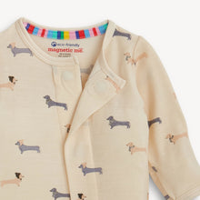 Load image into Gallery viewer, Close-up of the dachshund-print footie with its magnetic neckline opened, showing colorful striped inner trim.
