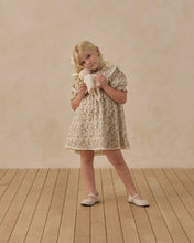 Load image into Gallery viewer, Child in a floral dress cuddling Rylee the Rabbit against their cheek.
