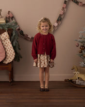 Load image into Gallery viewer, Fuzzy Cardigan in Ruby on a girl beside holiday stockings
