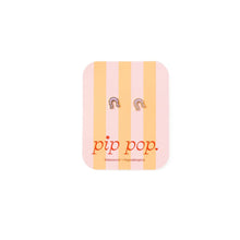 Load image into Gallery viewer, Pale pink and gold-tone horseshoe stud earrings displayed on a pink and peach striped Pip Pop card.
