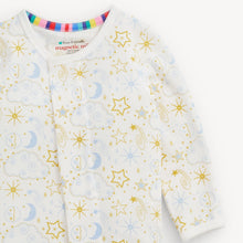 Load image into Gallery viewer, A close-up of a baby long-sleeve sleep sack or bodysuit with a white base, decorated with a pattern of gold stars, blue crescent moons, and light blue clouds. The inner collar features a colorful striped lining with a visible 'Eco-Friendly magnetic snap' brand label.
