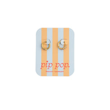 Load image into Gallery viewer, Gold-tone pink opal hoop earrings on a blue and peach striped Pip Pop display card.
