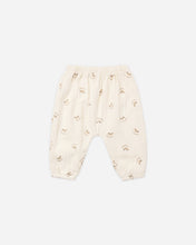Load image into Gallery viewer, Cream woven baby pants with an allover rocking-horse print, elastic waistband, and gathered ankle cuffs.

