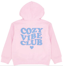 Load image into Gallery viewer, A light pink hoodie shown from the back, featuring the words 'COZY VIBE CLUB' in a light blue bubbly font with a small light blue heart underneath, on a solid white background.
